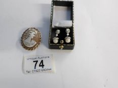 A pair of pearl set earrings and a 9ct gold cameo brooch