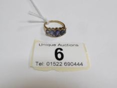 An old 9ct gold ring set 'iolite' gemstones,