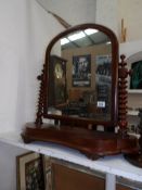 A Victorian mahogany toilet mirror with barley twist supports