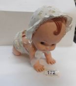 A vintage crawling doll