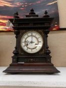 A late 19th century mantel clock with pendulum and key