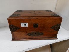 An early 20th century oak smokers box with brass mounts