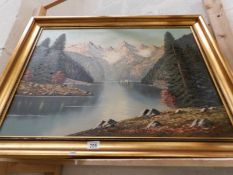 A gilt framed oil on canvas mountain and lake scene