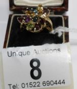 A 9ct gold ring set multi-gems in a floral 8 spray settings,