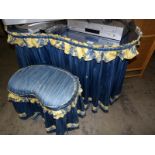 A kidney shaped dressing table and stool