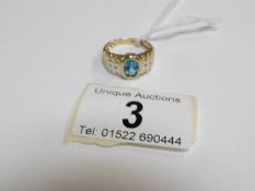 A 14kt ring set topaz and small diamonds.