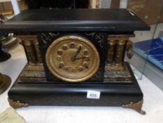 A black painted paladian style mantel clock