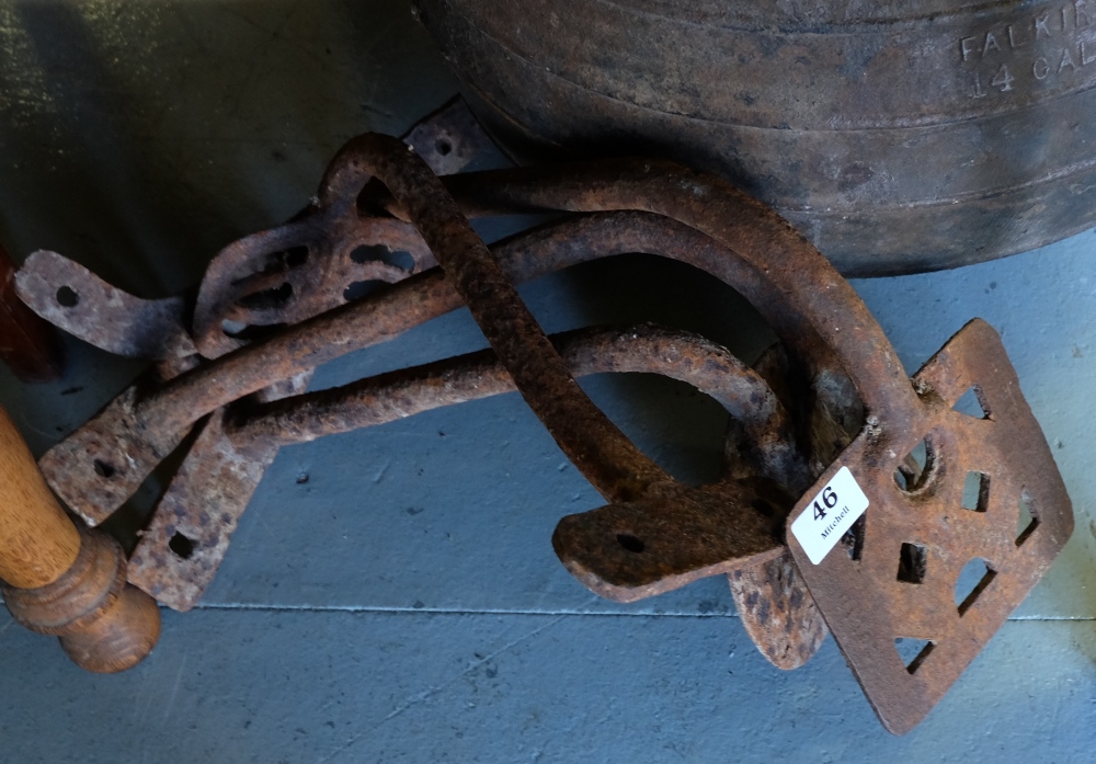 Two pairs of old iron trap steps.