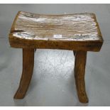 19thC Elm Stool, the concave shaped seat over four dowel jointed out-turned legs with stretchers,