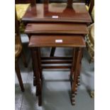 Nest of 3 mahogany tables, on spindle legs, (largest 27.5”h x 19”w).