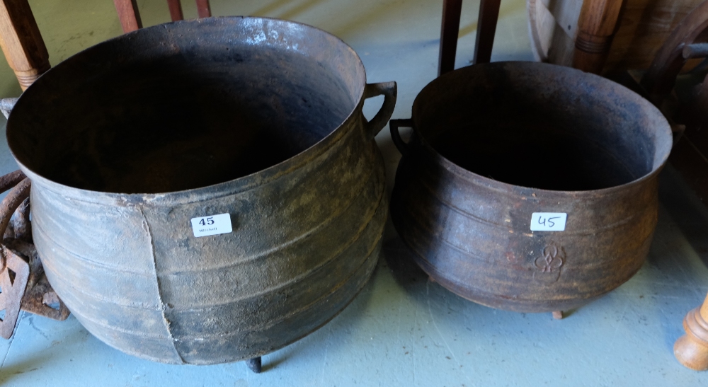 Two Irish metal skillet pots, incl. one 14 gallons, each raised on 3 feet.