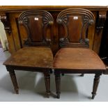 Matching pair of WMIV mahogany Hall Chairs, curved top rails over shield backs, on turned and reeded