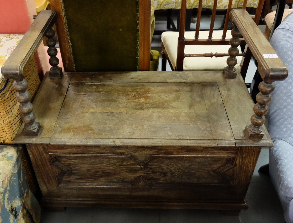 1920’s Oak Hall Bench, the hinged seat enclosing a chest, with raised side arms, on turned supports,
