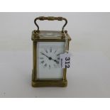 Brass framed Carriage Clock, the white dial with roman and Arabic numerals, 4”h, with key.