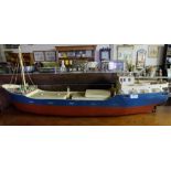 Wooden scale model of Fishing Trawler, painted blue and red, 42”w x 11”h.
