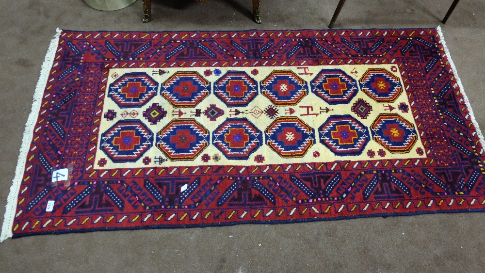 Hand woven Afghan Belouchi Floor Rug (a Tribal Rug), red and navy pattern border with beige interior