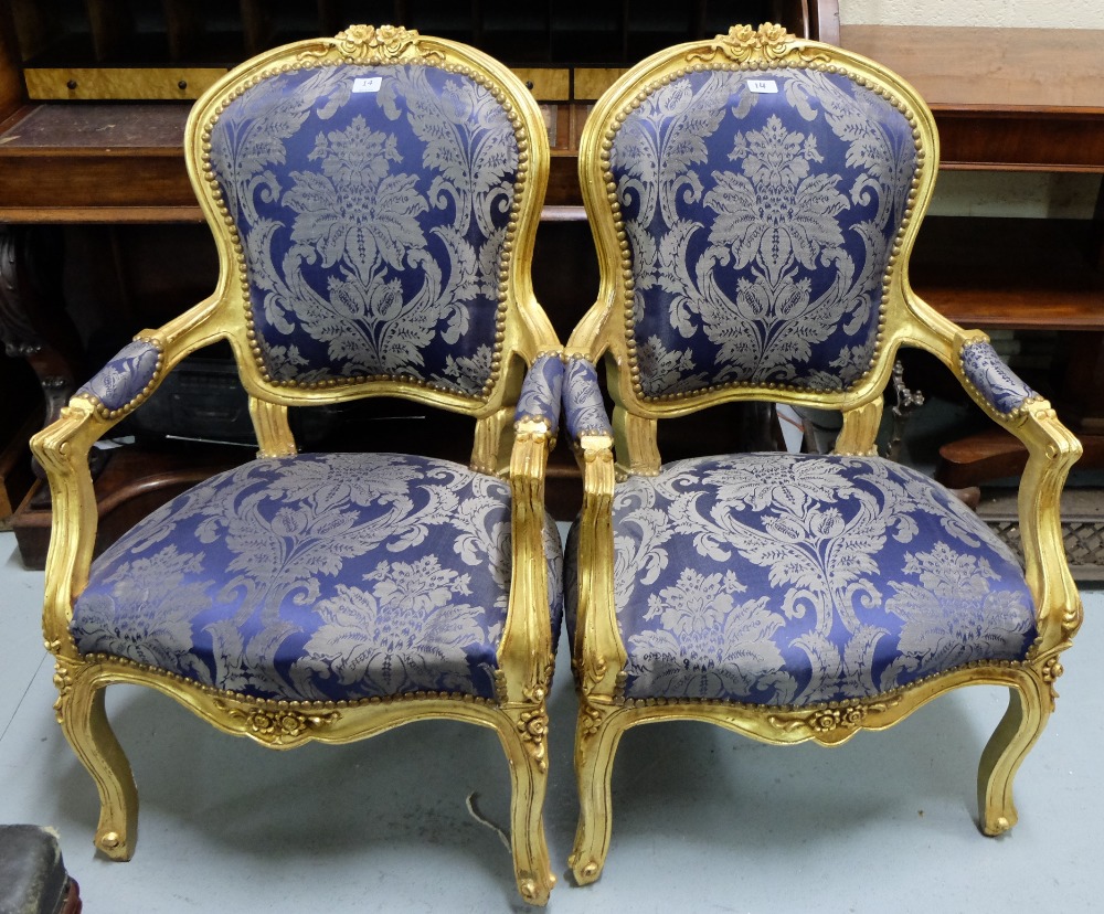Matching Pair of gilt decorated Armchairs, with curved top rails, on cabriole legs, blue floral