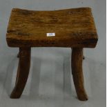 19thC Elm Stool, the concave shaped seat over four dowel jointed out-turned legs (1 repaired) with