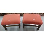 Matching pair of footstools, the red fabric covered padded seats over square reeded legs, with