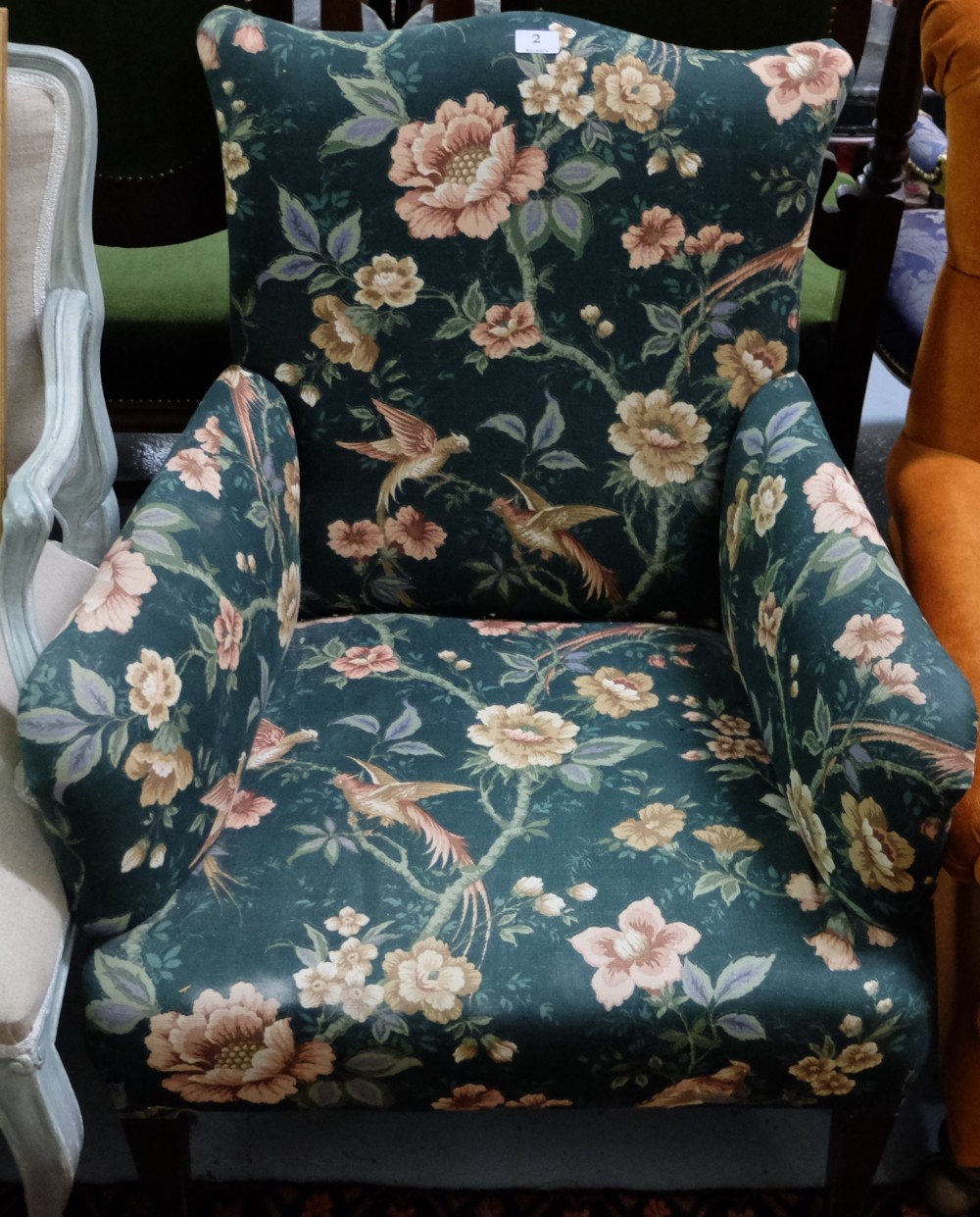 Edwardian Armchair, on tapered front legs and casters, green floral fabric.