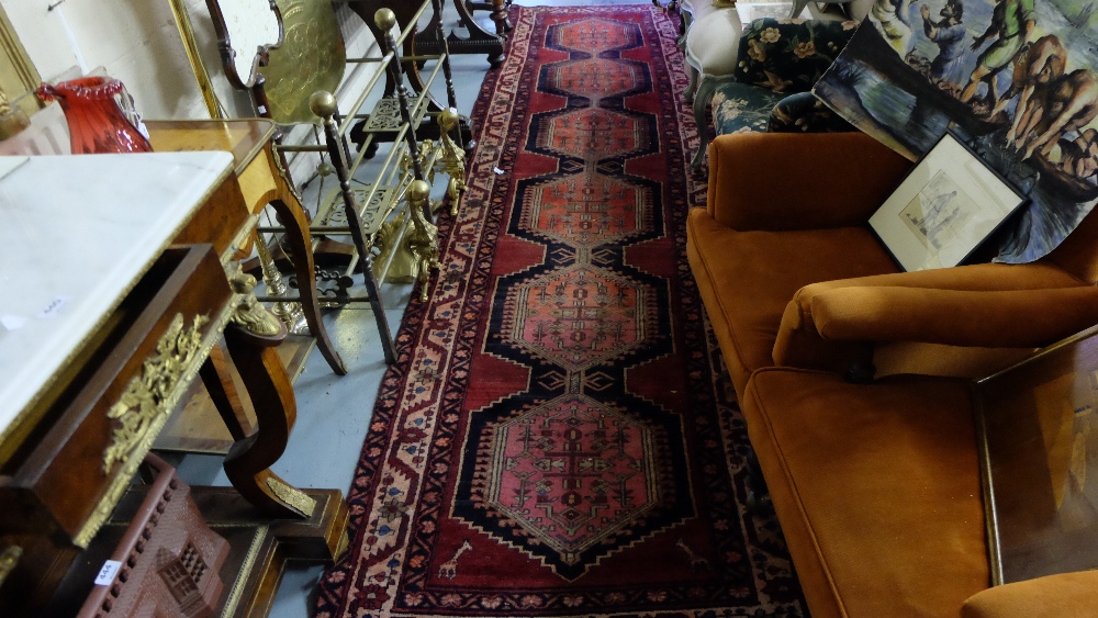 Large Persian Floor Runner, red ground with 6 multiple pattern medallions, 13ft x 3ft 3”.