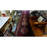 Large Persian Floor Runner, red ground with 6 multiple pattern medallions, 13ft x 3ft 3”.