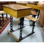 Matching pair of Pitch Pine School Desks with hinged tops, on metal bases, 1 stamped “Hearne”