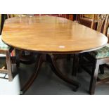 Edw. Oval End Mahogany Dining Table, with 2 removable leaves, on tripod base with brass toes, cup