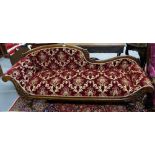 Vic. Mahogany framed Chaise Longe, the arched top rail over a scrolled side arm, covered in red