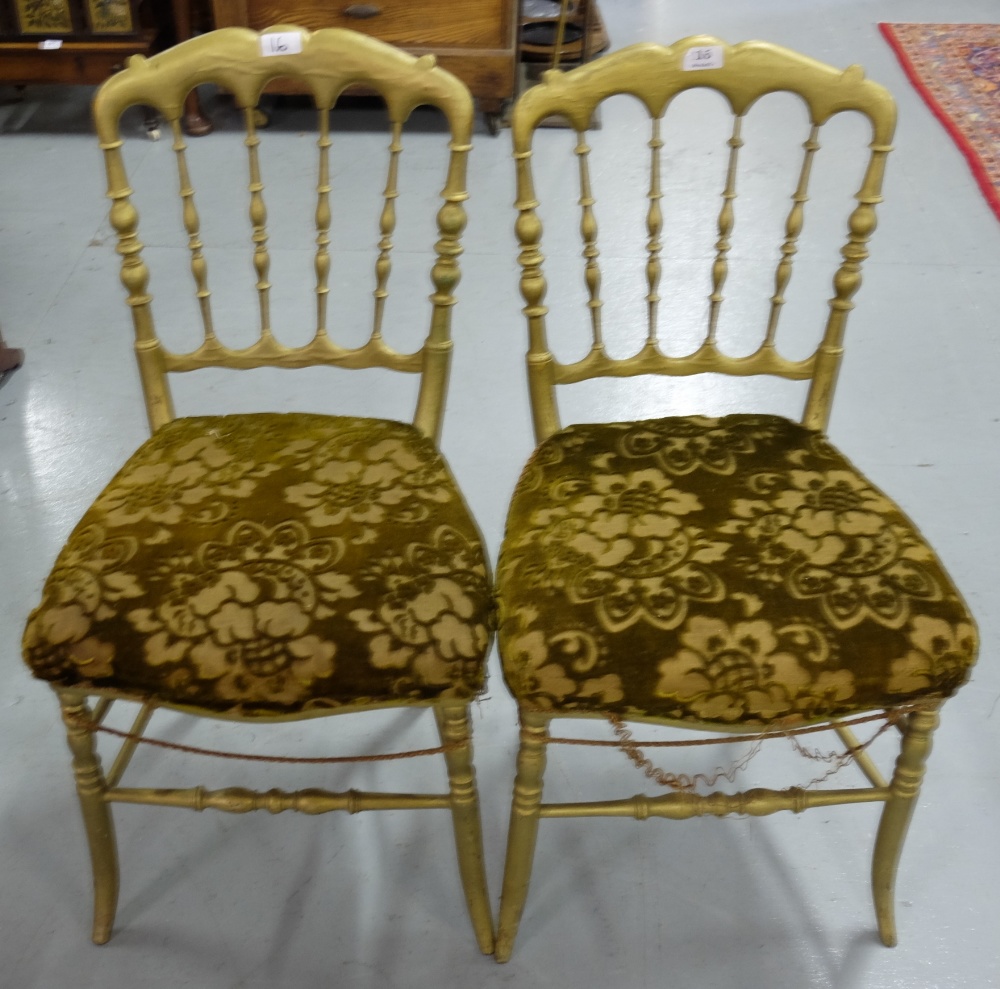 Matching pair of gilt decorated side chairs, with rail backs, out-swept legs.