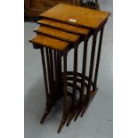 Nest of 4 walnut veneered tables, on turned and reeded legs, 29”h.