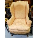 Late 19thC Wingback Armchair, the peach fabric covered oval back and seat and feathered cushion,