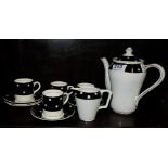 10 piece Edw. Pottery coffee set with coffee pot, black ground with cream pots.