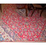 Persian Floor Rug, with central medallion and continuous red and navy floral pattern, 190 x 290