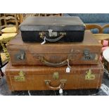 3 leather bound suitcases (2 brown, 1 black with interior compartments).