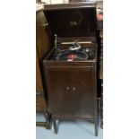 HMV record player, in oak case, with hinged lid and lower cabinet enclosing a speaker, 18”w