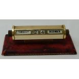 “Leathersmith” English brass framed revolving desk calendar on red leather base, 6”w