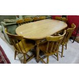 Modern oval kitchen table and matching set of 6 chairs with turned rail backs.