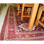 Large wool floor rug, red ground with multiple central medallion, 121” x 89”