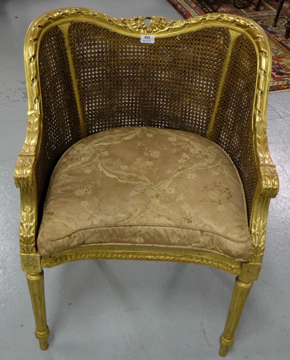 Carved Gilt Salon Armchair, with bergere back and sides, on turned front legs, loose feather