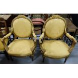 Matching Pair Ornate Gilt framed open Armchairs, gold satin fabric.