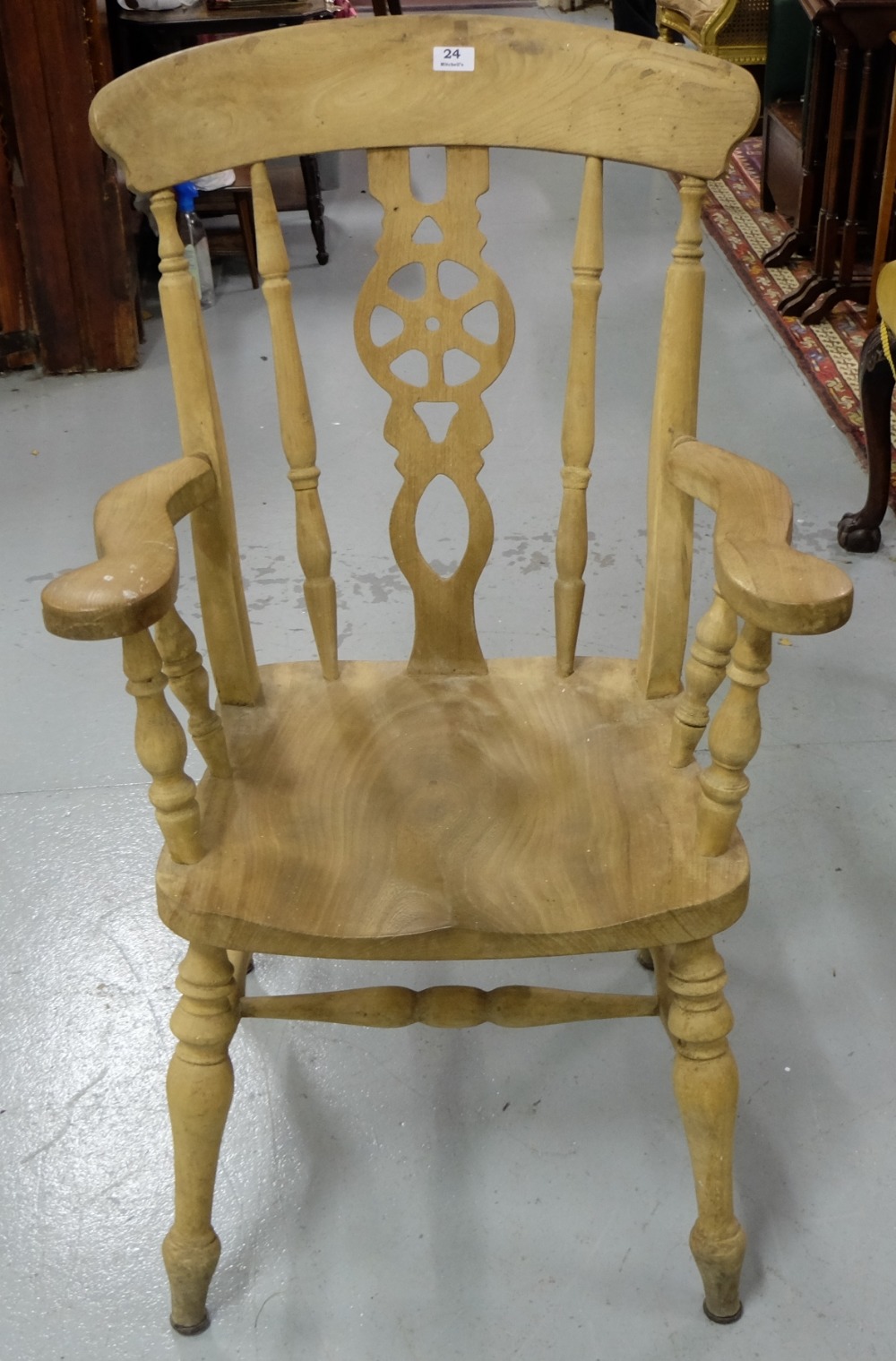 Stripped Pine Windsor Armchair, with wheel design splat, on turned legs.