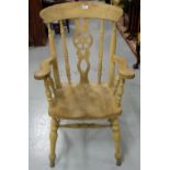 Stripped Pine Windsor Armchair, with wheel design splat, on turned legs.