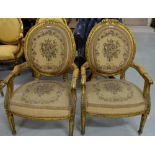 Matching Pair Carved Gilt Open Armchairs, with floral tapestry seats and backs.