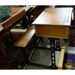 Two Pitch Pine School Desks, with fixed seats and hinged lids, on cast iron bases