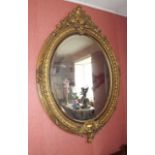 Large mirror mounted in a oval gilt fram