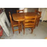 Small pine table with four pine chairs.