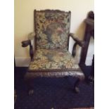 A highly carved open armchair a copy of