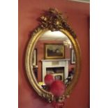 Large mirror mounted in a oval gilt fram