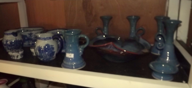 Shelf of various ceramic ware.